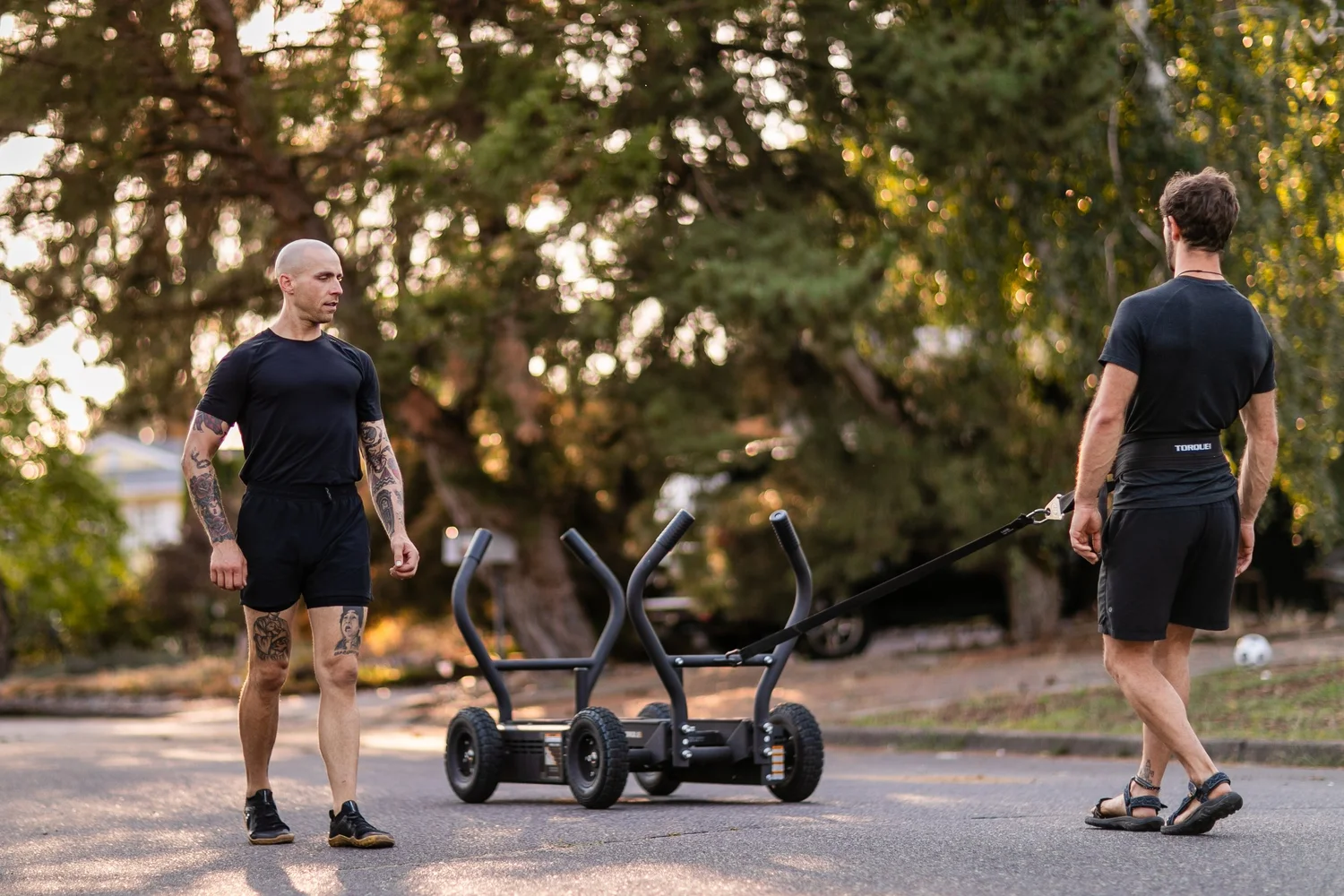 Adam pushing the sled during a training session at No Easy Feet
