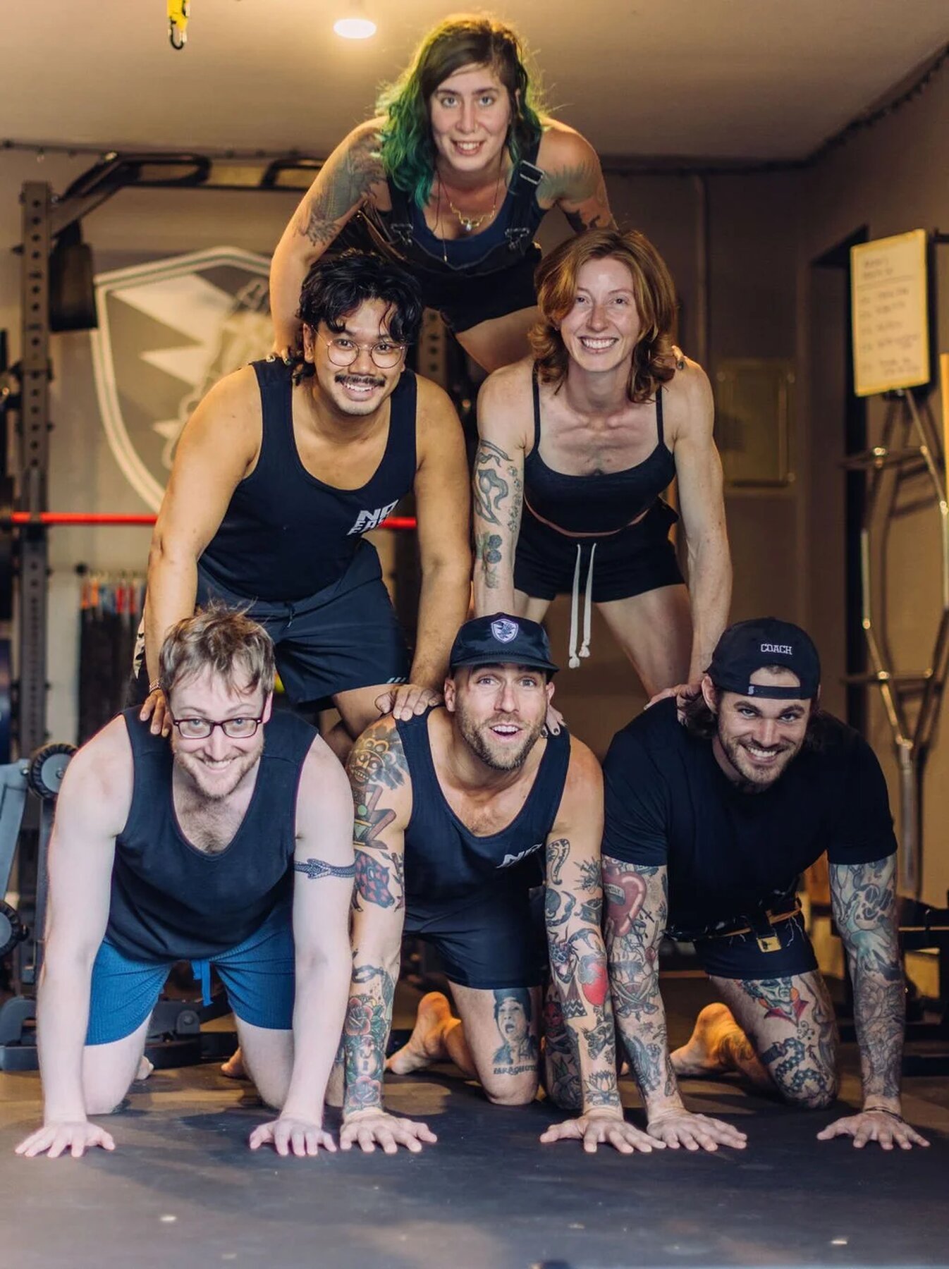 The No Easy Feet crew stacked in a pyramid at the SE Portland studio