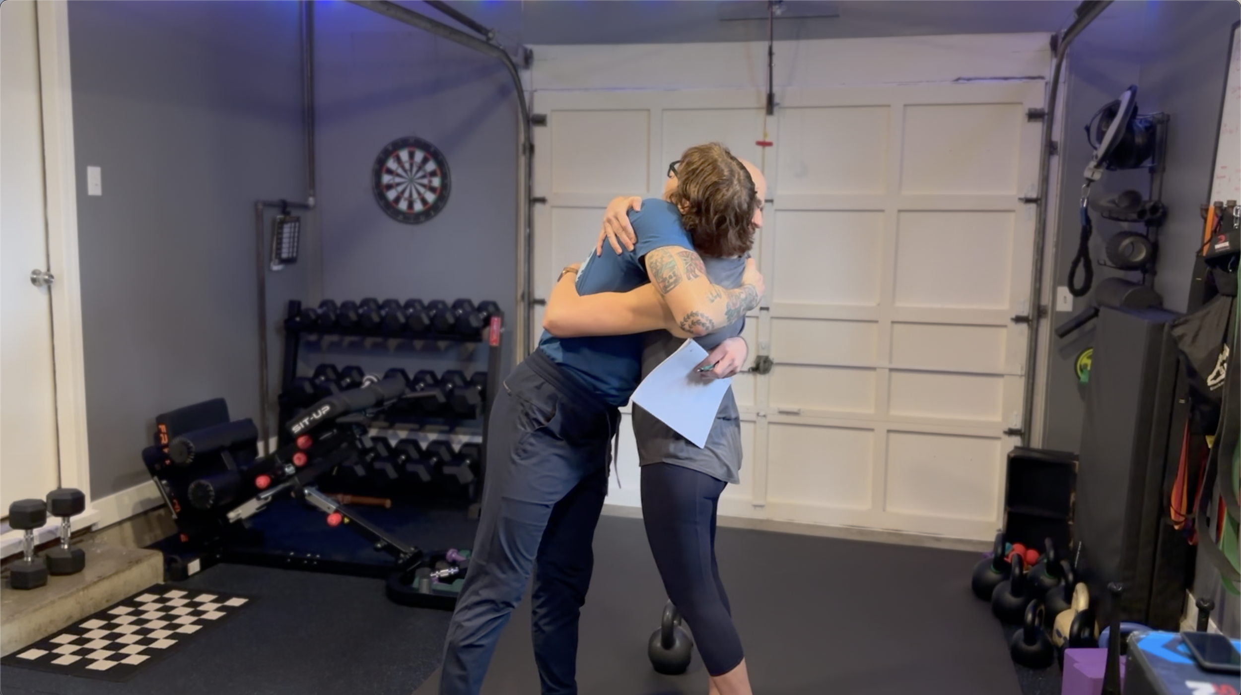 A coach and client share a hug at the No Easy Feet studio
