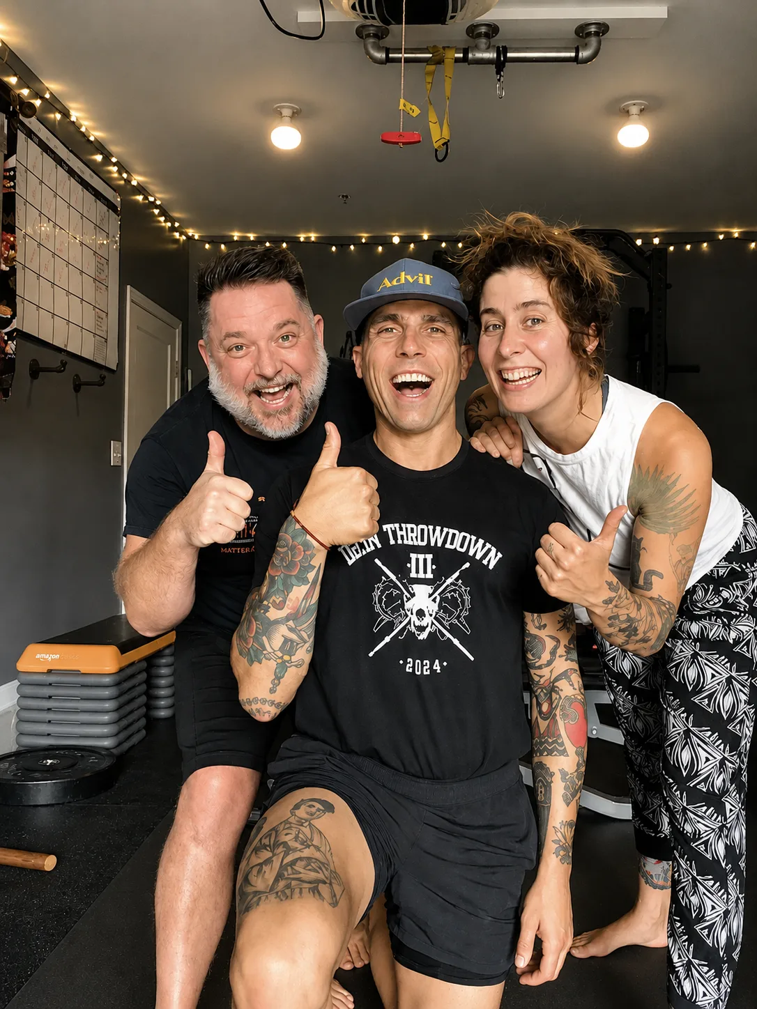 Three smiling No Easy Feet members giving thumbs up in the studio