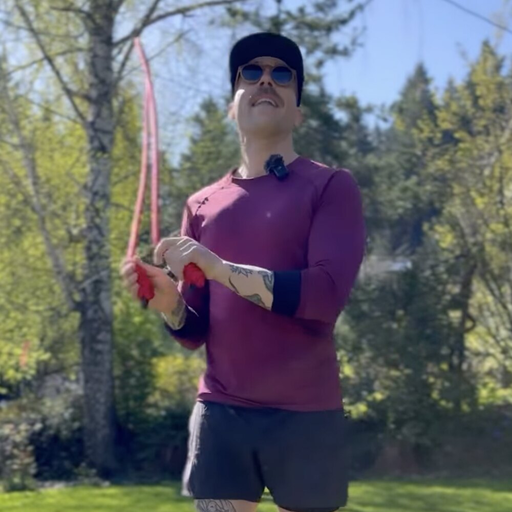 Adam training barefoot outdoors with a jump rope