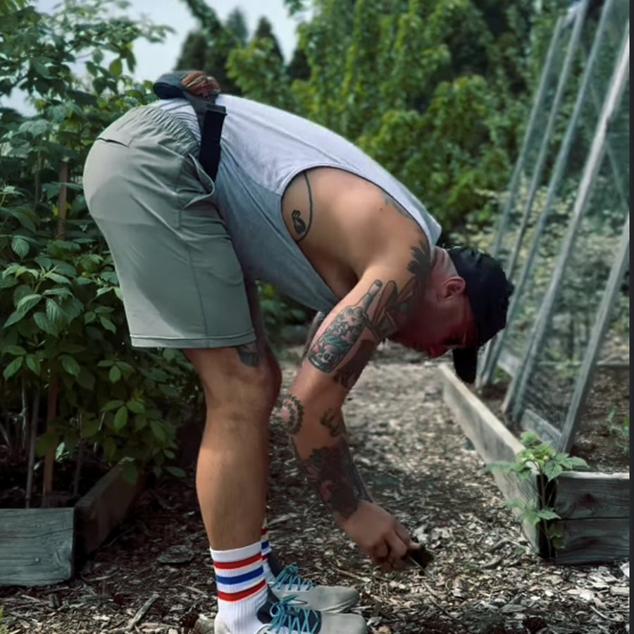 Adam tending a raised garden bed at the community garden