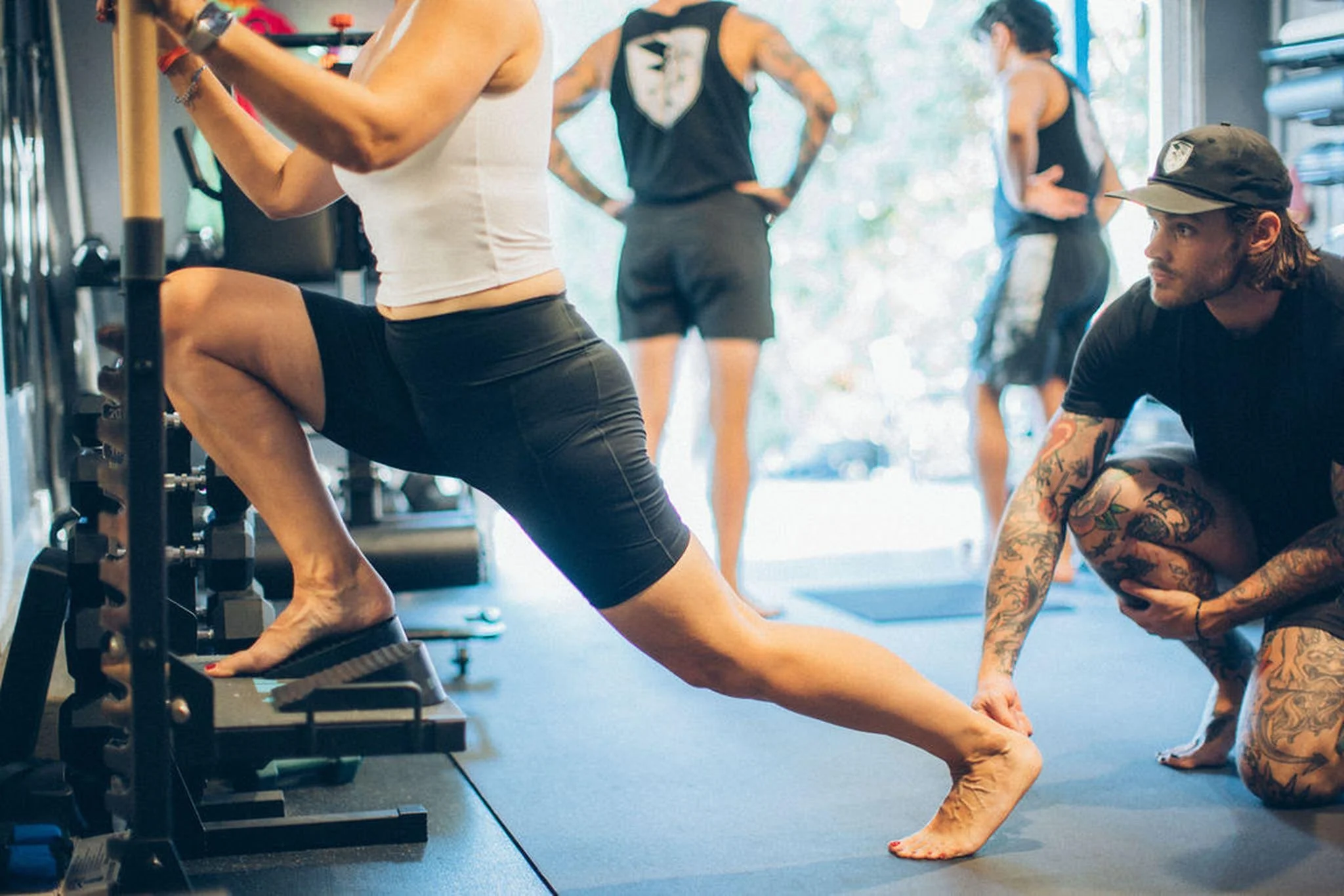 A client performing a knees-over-toes lunge at No Easy Feet