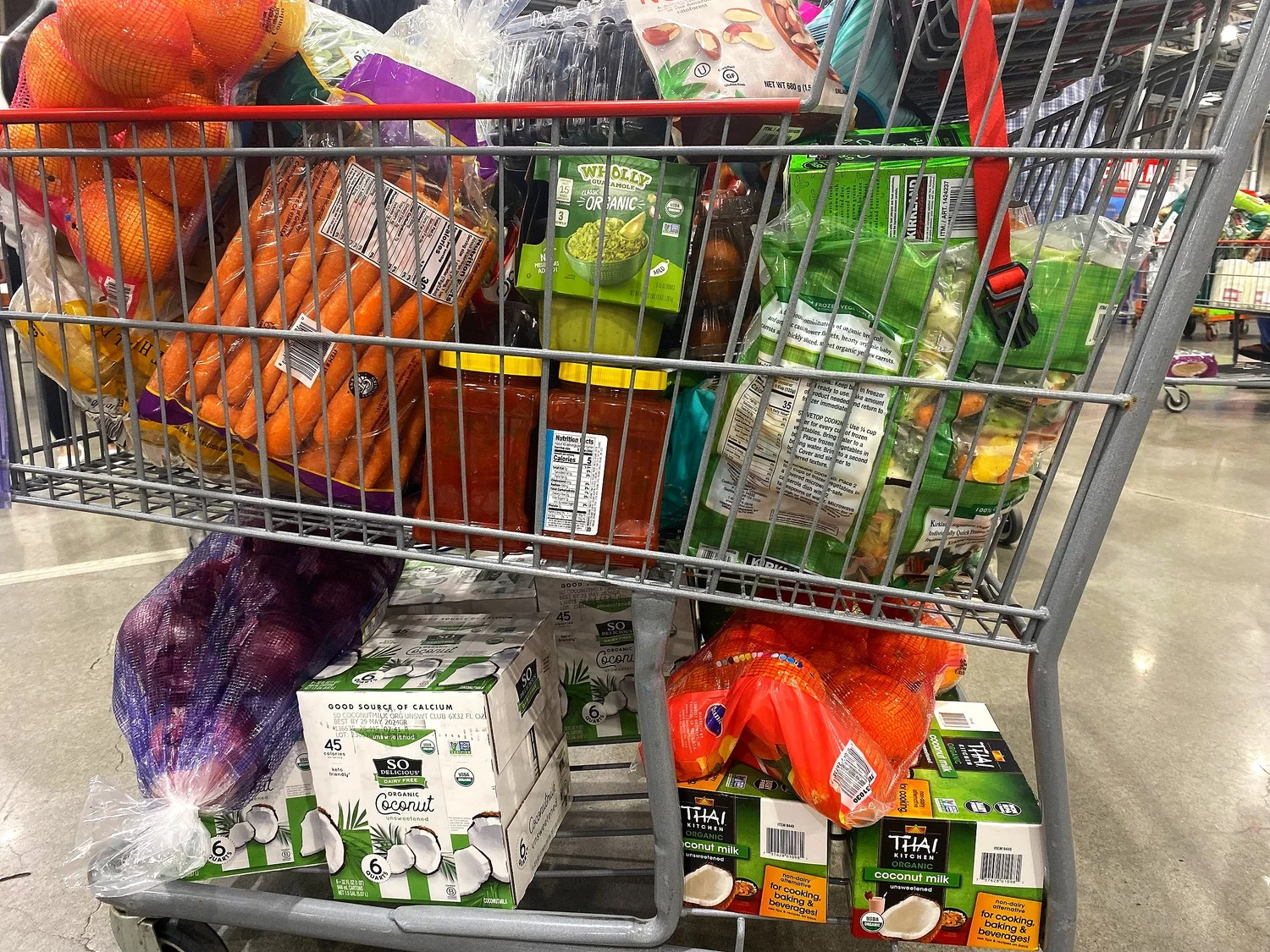 A Costco shopping cart with healthy groceries